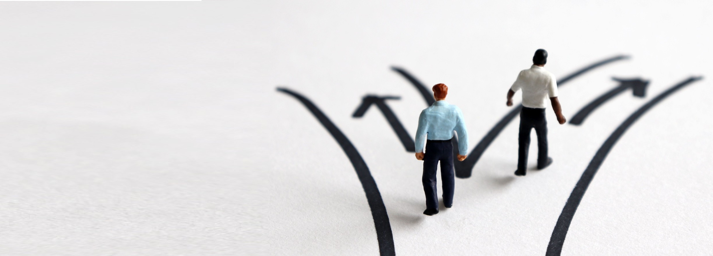Two business figures standing at diverging paths, representing decision points around using settlement agreements